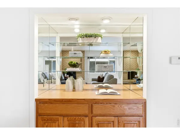 a dining room with furniture and a floor to ceiling window