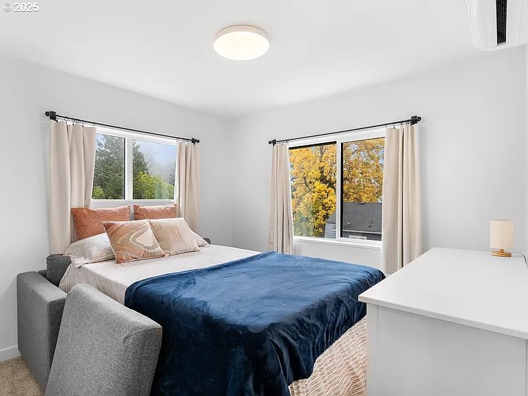 3590 Southwest Patton Road, Unit C Portland, OR 97221 - Photo 18 of 40 a bedroom with a large bed and a window