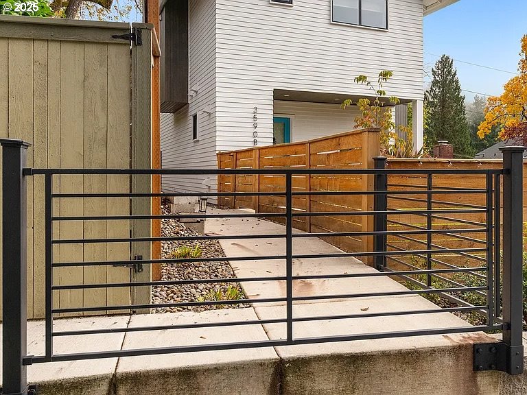 3590 Southwest Patton Road, Unit C Portland, OR 97221 - Photo 2 of 40 a view of a street with wooden fence