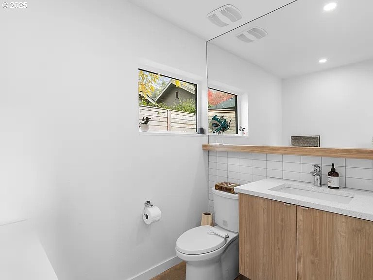 3590 Southwest Patton Road, Unit C Portland, OR 97221 - Photo 10 of 40 a bathroom with a toilet sink and mirror