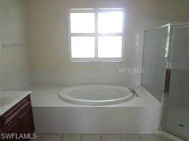a white bath tub sitting next to a window