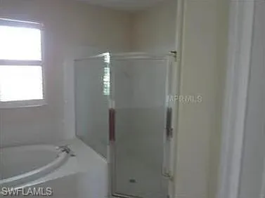 a bathroom with a bathtub and shower