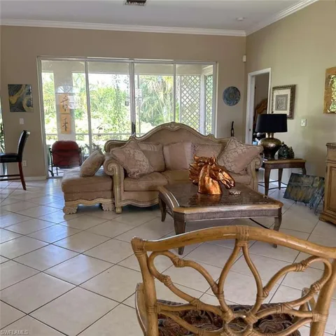 a living room with furniture and large windows