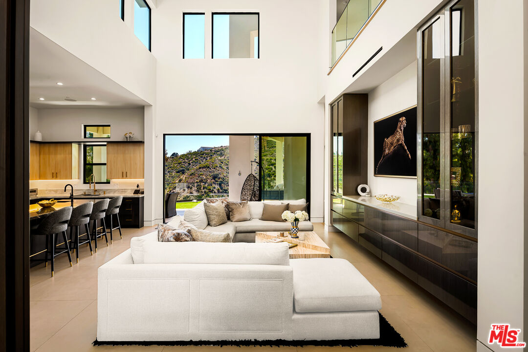 1367 Casiano Road Los Angeles, CA 90049 - Photo 4 of 26 a living room with furniture and large windows
