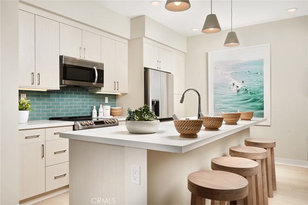 4882 Long Beach Boulevard Long Beach, CA 90805 - Photo 4 of 6 a kitchen with a sink a stove and white cabinets