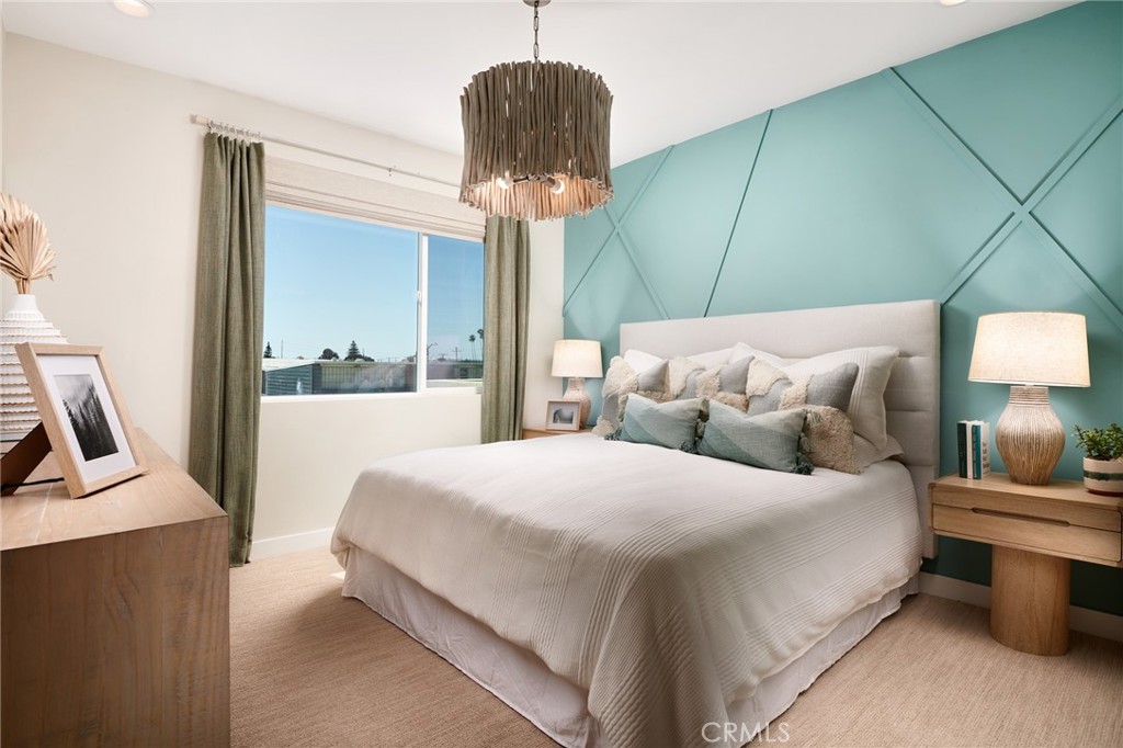 4882 Long Beach Boulevard Long Beach, CA 90805 - Photo 5 of 6 a bedroom with a bed a mirror and a window