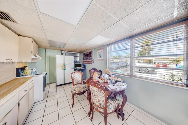 a open kitchen with stainless steel appliances granite countertop a stove a refrigerator a sink dishwasher with a dining table and chairs
