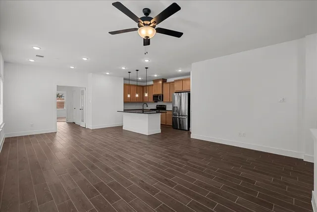 a view of a kitchen with a sink and a refrigerator