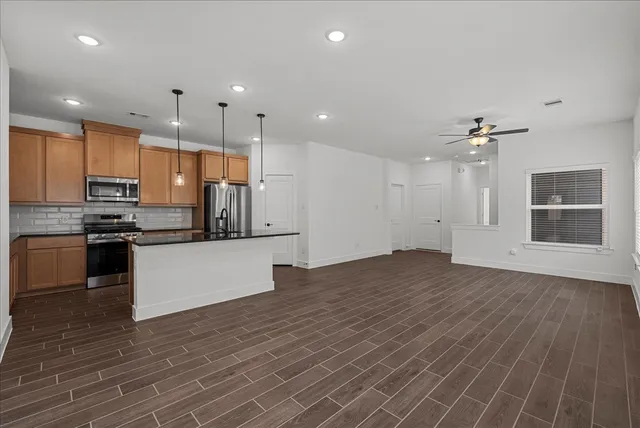 a view of kitchen with sink microwave and stove