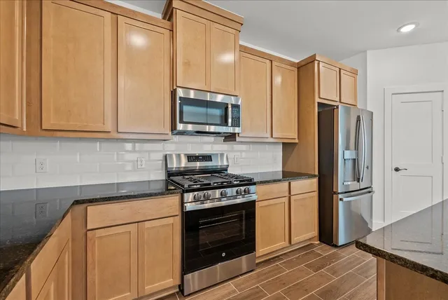 a kitchen with a refrigerator stove and microwave
