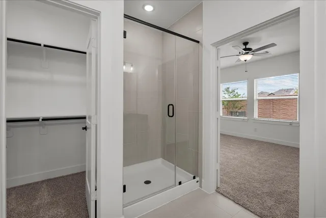 a bathroom with a shower and a window