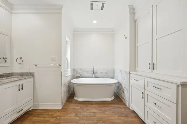 a spacious bathroom with a granite countertop sink and a mirror