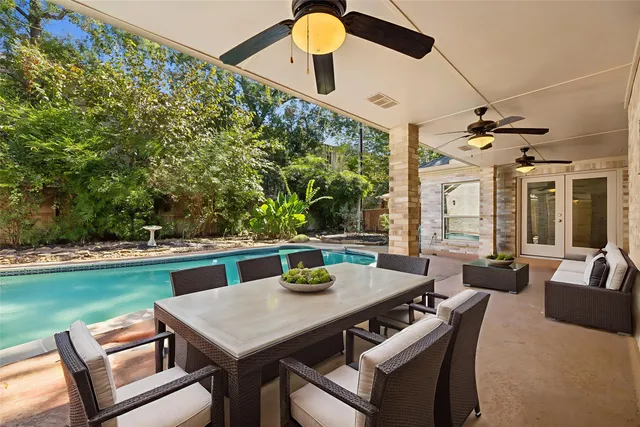 a view of a dining table and chairs in the patio