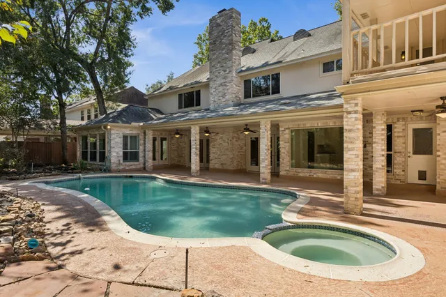 a view of a house with backyard and sitting area