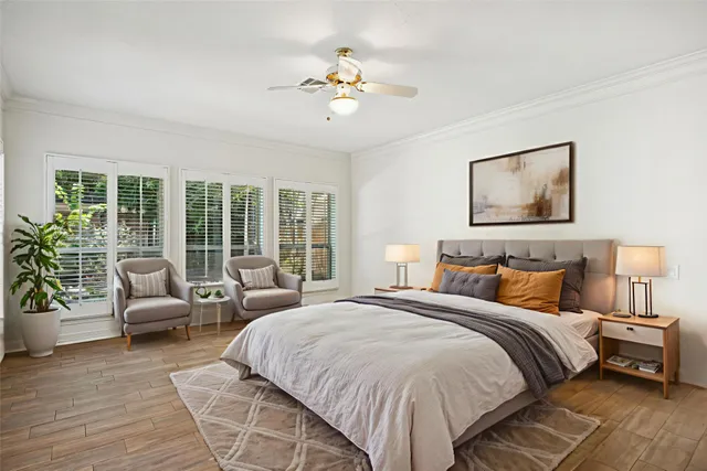 a bedroom with a large bed and a chandelier