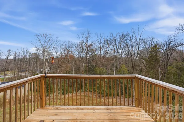 a view of balcony with wooden floor and fence