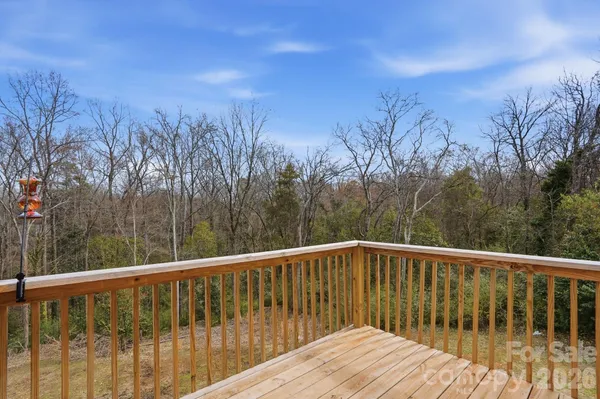 a view of balcony with wooden fence and floor