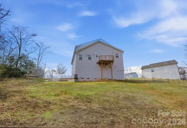 a backyard of a house with large trees