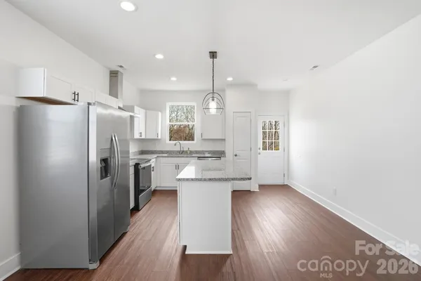 a kitchen with refrigerator a sink and cabinets