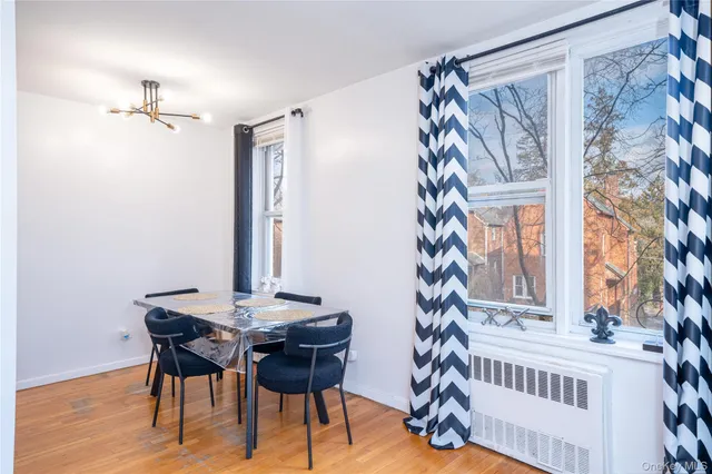 a view of a dining room with furniture and chandelier