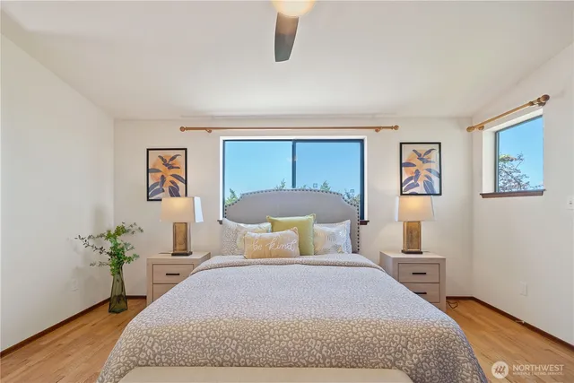 a bedroom with a bed and painting on the wall