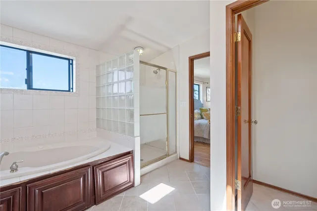 a bathroom with a bathtub and a shower