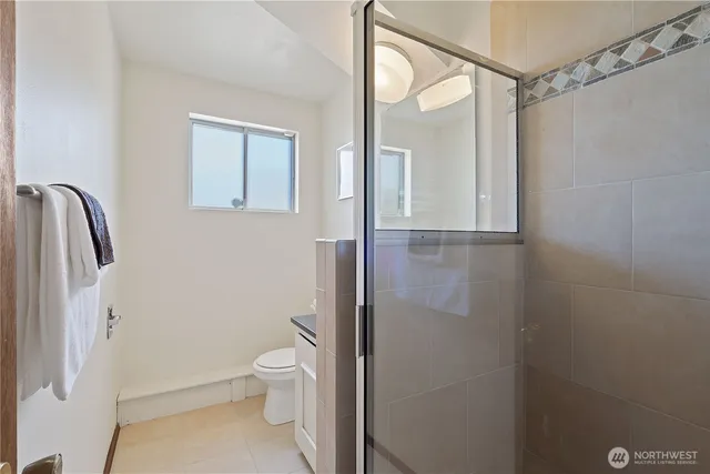 a bathroom with a glass shower door