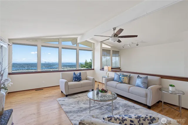 a living room with furniture and floor to ceiling windows