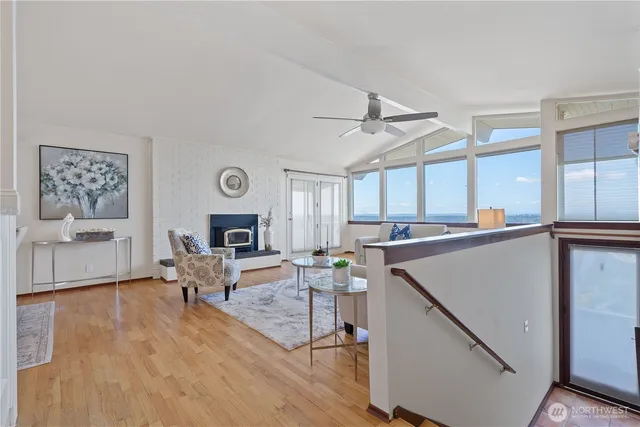 a living room with furniture a fireplace and a large window