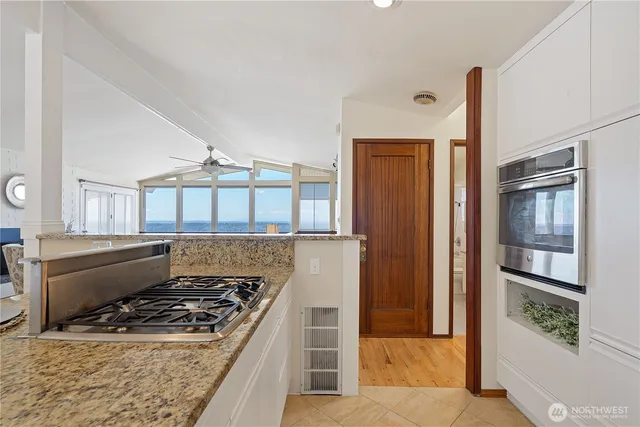 a kitchen with a stove and a refrigerator