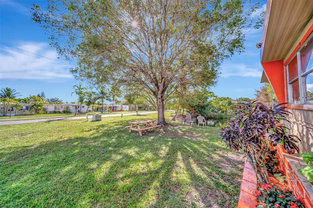 a view of yard with swimming pool and green space