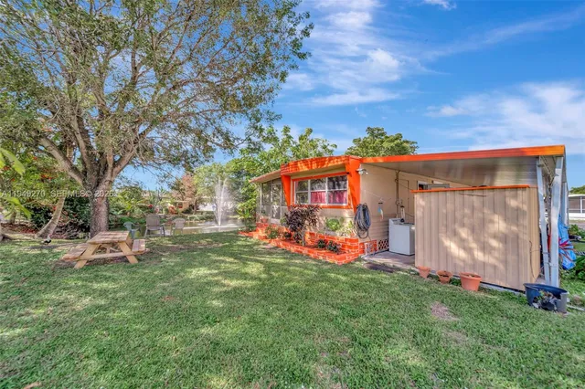 a view of a house with garden and sitting area