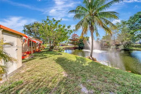 a view of swimming pool with a yard and a bench