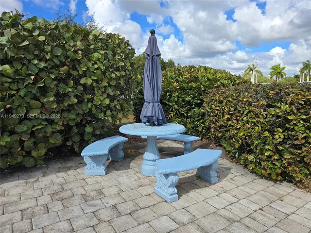 a room with pool table and windows