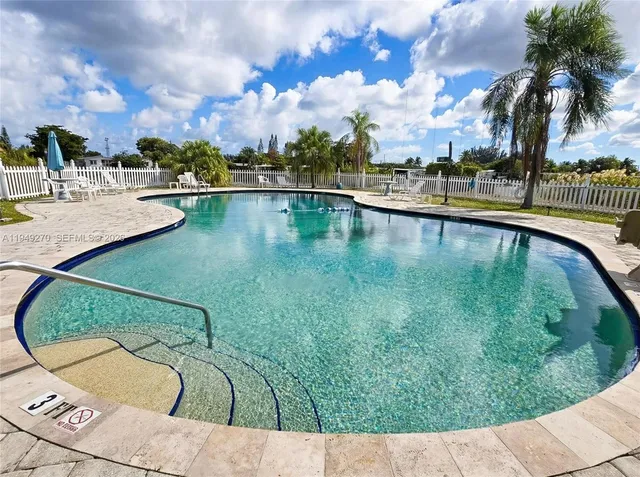 a view of swimming pool with a lounge chairs