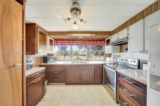 a kitchen with stainless steel appliances granite countertop a sink and cabinets