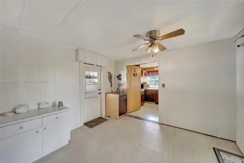 a en suite bathroom with a granite countertop sink mirror and a toilet