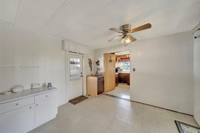 a en suite bathroom with a granite countertop sink mirror and a toilet