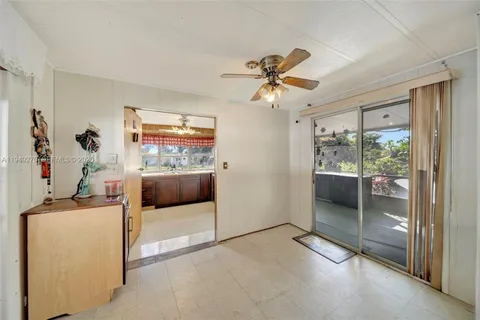 a view of a livingroom with a window and a ceiling fan