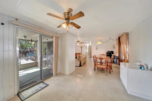 a view of a livingroom with furniture and a ceiling fan