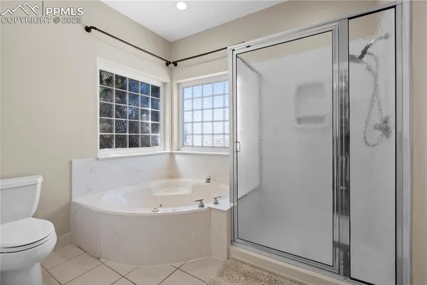 a white bath tub sitting next to a toilet