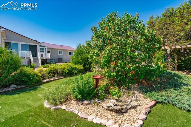 a view of a garden with a building in the background