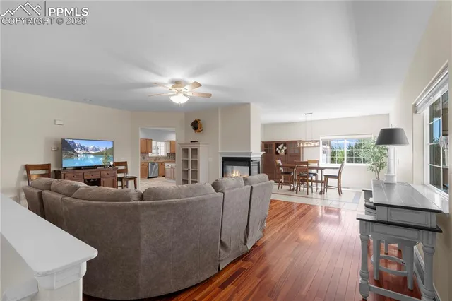 a living room with fireplace furniture and a wooden floor