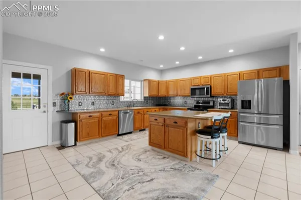 a kitchen with stainless steel appliances granite countertop a stove top oven a sink a counter top space and cabinets