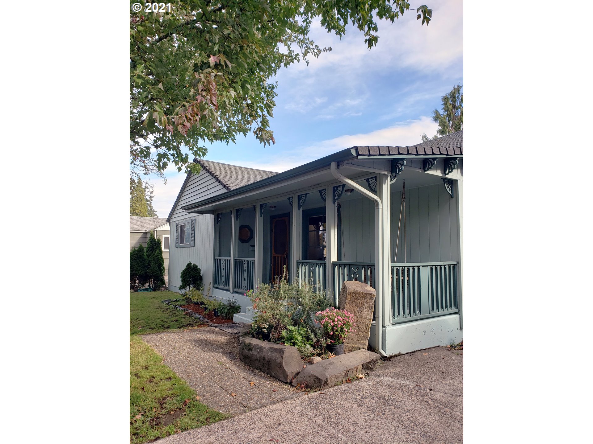 235 North 24th Street Springfield, OR 97477 - Photo 2 of 24 a view of a house with a small yard plants and large tree