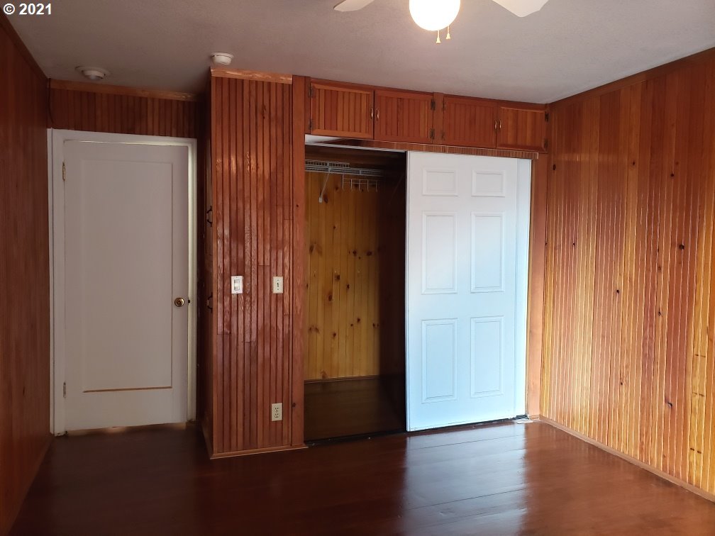 235 North 24th Street Springfield, OR 97477 - Photo 14 of 24 an empty room with wooden floor and a cabinet