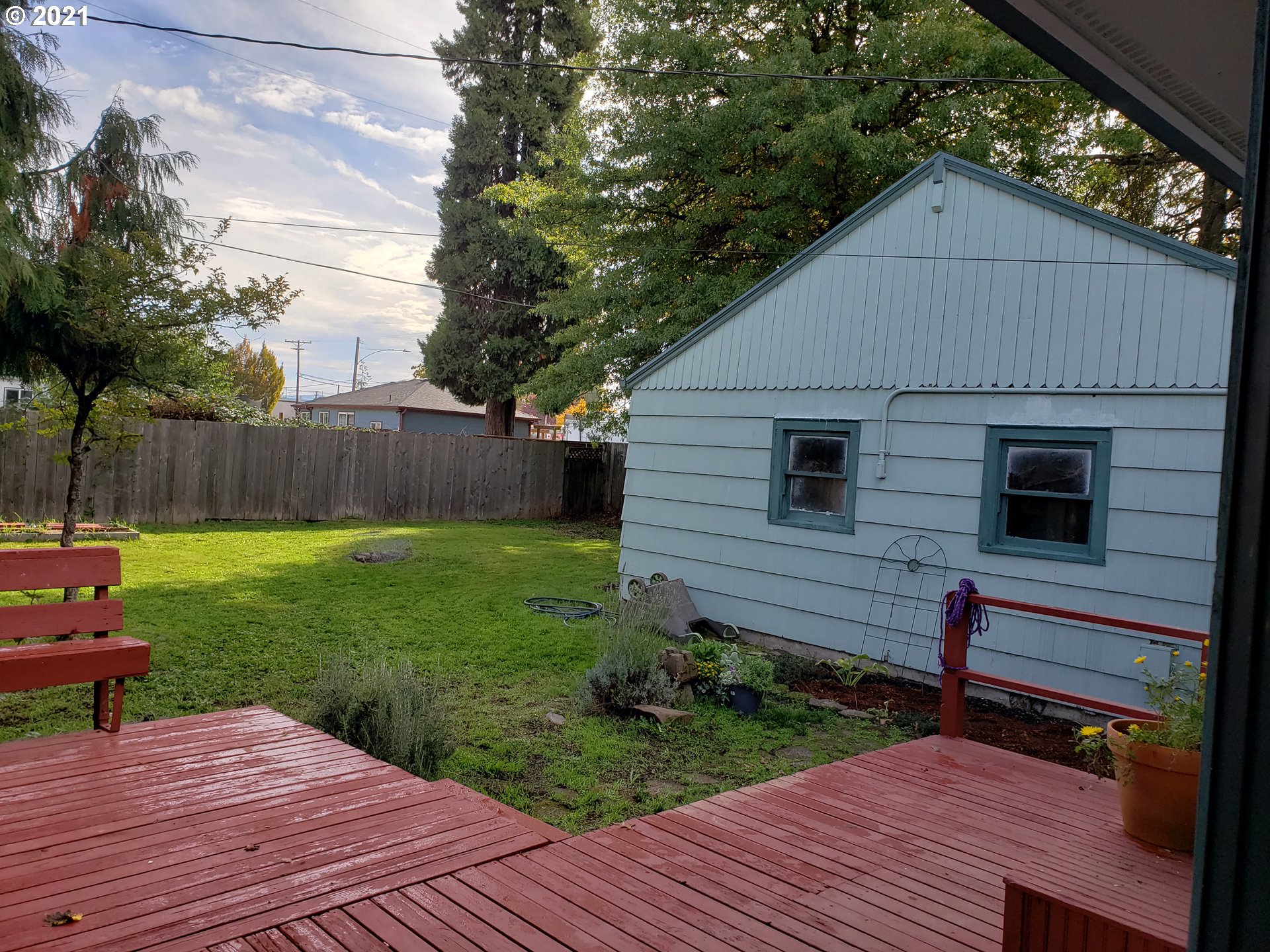 235 North 24th Street Springfield, OR 97477 - Photo 10 of 24 a view of backyard with table and chairs and wooden fence