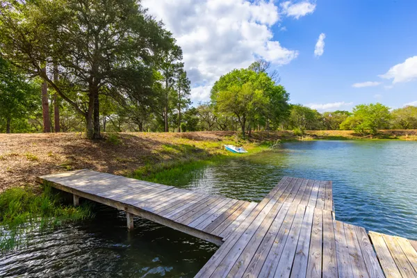 a view of a wooden deck with lake view