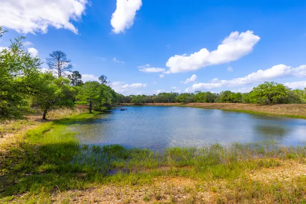 a view of a lake with houses in the background