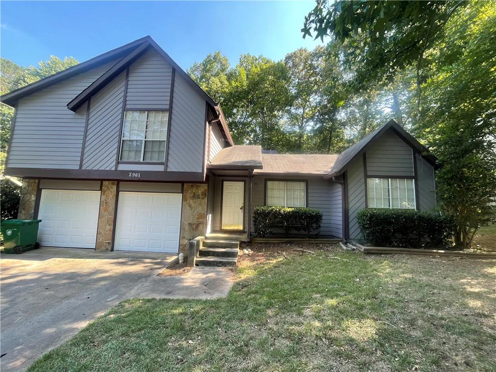 2961 Knollberry Lane Decatur, GA 30034 - Photo 1 of 1 a front view of a house with a yard and garage